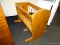 (R3) DOLL CRIB; ROCKING, PINE DOLL'S CRIB WITH AN ARCHED TOP ON ONE SIDE. MEASURES 27.5
