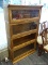 (R1) BARRISTER BOOKCASE; OAK, 4-SHELF BARRISTER BOOKCASE. MISSING ONE OF THE GLASS FRONTS. MEASURES