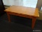 (R1) COFFEE TABLE; STAINED PINE, RECTANGULAR COFFEE TABLE. MEASURES 35