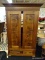 (R4) ANTIQUE WARDROBE; WALNUT WARDROBE WITH A FLARED CORNICE TOP, 2 CABINET DOORS REVEALING A LARGE