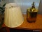 (R1) OCTAGONAL TABLE LAMP; POLISHED BRASS TABLE LAMP WITH A POTTED PLANT SCENE CUT ONTO 4 OF THE