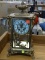 (R2) ANTIQUE GILBERT CLOCK COMPANY GLASS AND BRASS MANTEL CLOCK WITH ORNATE DETAILING. MEASURES 8