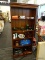 (R2) RIVERSIDE FURNITURE CO. BOOKCASE; 4-SHELF, NATURAL FINISHED BOOKCASE WITH A WOOD PLANK BACK.