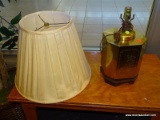(R1) OCTAGONAL TABLE LAMP; POLISHED BRASS TABLE LAMP WITH A POTTED PLANT SCENE CUT ONTO 4 OF THE
