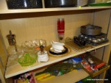 (SHELVES) SHELF LOT; INCLUDES A GREEN DEPRESSION GLASS LEMON JUICER, MUFFIN DISHES, SIFTERS, A GLASS