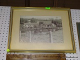 (LWALL) FRAMED PHOTOGRAPH; DEPICTS A GROUP OF OLD HOES ON THE WATER'S EDGE WITH ROLLING FIELDS IN