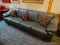 TWO PIECE GRAY LEATHER FOUR CUSHION SOFA WITH MACHINE STICHED TRIMM.