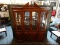 MAHOGANY CHIPPENDALE 2-PIECE BREAK FRONT. LIGHTED HUTCH TOP WITH MIRRORED BCAK AND GLASS SHELVES.