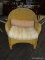 WICKER ARM CHAIR WITH OUTDOOR CUSHION. WICKER DAMAGE IN SEVERAL AREAS.
