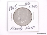 1965 40% SILVER KENNEDY HALF DOLLAR IN PROTECTIVE SLEEVE.