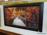 (R3) A FALL WALK PHOTO ON BOARD DEPICTING A FOOT BRIDGE SURROUNDED BY BEAUTIFUL FALL COLORED LEAVES.