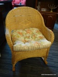 WICKER ROCKER WITH OUTDOOR CUSHION. WICKER DAMAMGE IN SEVERAL AREAS.