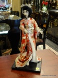 14 IN TALL GEISHA GIRL ON STAND WITH HANDSTITCHED KIMONO.