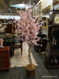 APPROX 6 FOOT TALL ARTIFICAL CHERRY BLOSSOM TREE IN A WICKER POT.