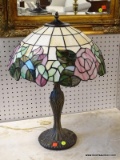 22 IN TALL LAMP WITH LEADED GLASS FLORAL SHADE AND BRONZE LILLY LAMP BASE.