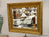 GOLD GILD SHADOWBOXED BEVELED MIRROR AND VERY ORNATE FRAME. MEASURES 27.5 X 23.5