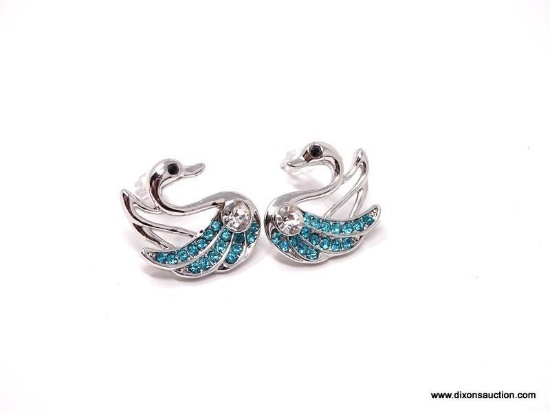A BEAUTIFUL PAIR OF GRACEFUL SWAN RHODIUM PLATED EARRINGS, SET WITH ROUND CUT CRYSTALS. TEAL BLUE