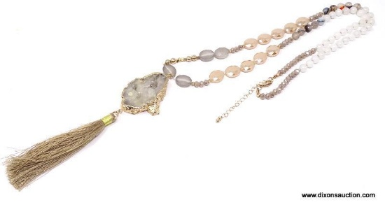 GOLD EDGED AGATE GEODE SLICE PENDANT WITH SILK TASSEL ON EARTH TONE BEADED NECKLACE. THIS EYE