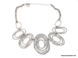 DESIGNER SIGNED, ERICA LYONS MODERNIST SILVER TONE HAMMERED SWIRL STATEMENT NECKLACE. FEATURES 7