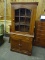 SMALL WOODEN CHINA CABINET WITH GLASS FRONT DOOR, 2 SHELVES,AND LOWER DOOR WITH STORAGE ARE.