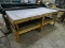 BENCHMADE WOODEN WORK TABLE WITH SHEET METAL TOP. MEASURES APPROX. 7' 11