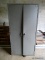 METAL 2-DOOR STORAGE CABINET. DENTED AND BOWED, HAS TROUBLE OPENING AND CLOSING. MEASURES 36