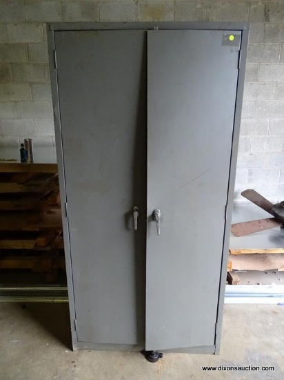 METAL 2-DOOR STORAGE CABINET. DENTED AND BOWED, HAS TROUBLE OPENING AND CLOSING. MEASURES 36" X 18"