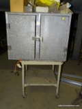 METAL TWO DOOR STORAGE CABINET ON TOP OF ROLLING TWO TIER CART. DOES NOT INCLUDE CONTENTS. CABINET