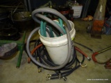 LOT OF ASSORTED HOSES. INCLUDES: GARDEN WATER HOSES, WASHING MACHINE HOSES, AND A 5 GAL BUCKET.