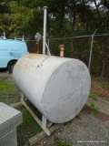 METAL DRUM STYLE OIL TANK WITH ROTARY PUMP AND HOSE. MEASURES 5' 4' X 3' 10