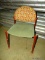 RETRO SIDE CHAIR. GREEN UPHOLSTERED SEAT AND GEOMETRIC BACK.