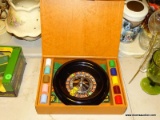 (FM) ROULETTE SET; MINIATURE ROULETTE GAMBLING SET. INCLUDES THE BOARD, COLORED CHIPS, MANUAL, AND