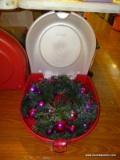 (FM) WREATH; HOLIDAY WREATH IN PROTECTIVE CASE. HAS PURPLE CHRISTMAS ORNAMENT ACCENTS.
