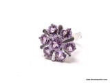 .925 STERLING SILVER & AMETHYST STARBURST FLOWER RING. COMES WITH BOX. RING SIZE IS 7-1/2.