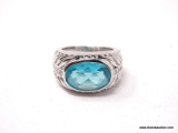 TECHNIBOND PLATINUM PLATING OVER .925 STERLING SILVER RING WITH LARGE OVAL SWISS TOPAZ GEMSTONE.