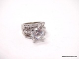 .925 STERLING SILVER RING WITH LARGE CENTER ROUND CZ GEMSTONE SURROUNDED BY MULTIPLE BAGUETTE CUT CZ