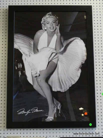MARILYN MONROE FRAMED PRINT; SHOWS MARILYN IN HER ICONIC VENT POSE IN BLACK AND WHITE. IS IN A BLACK