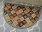 DEMILUNE FLOOR MAT; IS BURGUNDY, GREEN, AND CREAM IN COLOR. IS IN EXCELLENT CONDITION AND MEASURES 3