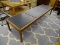 COFFEE TABLE; MAHOGANY 3 PANEL COFFEE TABLE WITH BLACK PANELS. IS IN EXCELLENT CONDITION AND