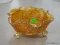 CARNIVAL GLASS BOWL; HAS A BERRY AND BUTTERFLY PATTERN WITH BALL AND CLAW FEET. IS IN EXCELLENT