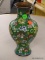 CLOISONNE VASE; GREEN, YELLOW, BLUE, AND RED FLORAL CLOISONNE VASE. HAS A DENT IN 1 SIDE. MEASURES 9