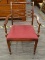 ARM CHAIR; MAHOGANY AND BURGUNDY UPHOLSTERED SEAT ARM CHAIR WITH A CARVED AND PILLOW BACK. IS IN