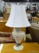 TABLE LAMP; URN STYLE LAMP IN CREAM WITH A CLOTH SHADE & CREAM COLORED FINIAL. IS IN VERY GOOD