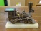 BRASS TRAIN MODEL; BRASS MODEL TRAIN THAT SITS ON AN ONYX BASE. IS IN EXCELLENT CONDITION AND