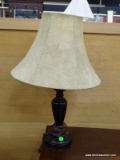 TABLE LAMP; BLACK URN SHAPED LAMP WITH A MARBLE COLORED CLOTH SHADE AND BRASS FINIAL. IS IN