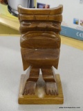 CARVED TIKI HEAD; SOLID WOODEN CARVED TIKI ON SQUARE BASE. IS IN EXCELLENT CONDITION AND MEASURES 5