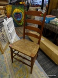 CHERRY SIDE CHAIR; HAS ACORN FINIALS, A LADDER BACK, AND A RUSH BOTTOM SEAT. IS IN VERY GOOD