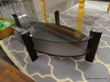 COFFEE TABLE; GLASS AND ESPRESSO FINISH COFFEE TABLE IN EXCELLENT CONDITION. MEASURES 28 IN X 52 IN