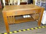 DESK; OAK DESK WITH A SINGLE DRAWER WITH BRASS PULLS, BUILT IN SIDE SHELVES AND A LOWER SHELF