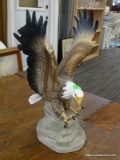 CERAMIC EAGLE STATUE; STATUE IS IN THE FORM OF A BALD EAGLE WITH CLAWS OUTSTRETCHED TO CAPTURE PREY.